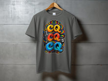 Load image into Gallery viewer, Grey t-shirt with a colorful graphic of three "CQ"s, a microphone, and a radio dial.
