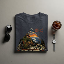 Load image into Gallery viewer, Dark grey t-shirt with a graphic of a person using a radio at a mountain summit.