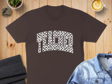 Load image into Gallery viewer, Brown t-shirt with "TEACHER" in a checkerboard pattern, laid flat.