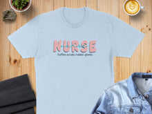 Load image into Gallery viewer, Light blue t-shirt with "Nurse" in pink and blue text and smaller text below.