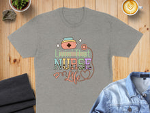 Load image into Gallery viewer, Grey t-shirt with "Livin' That Nurse Life" in colorful text and stethoscope.