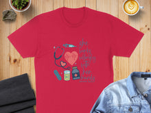 Load image into Gallery viewer, Red t-shirt with stethoscope, syringe, and "she works willingly with her hands" text.