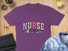 Load image into Gallery viewer, Purple t-shirt with "NURSE LIFE" text and medical icons.