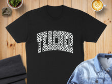 Load image into Gallery viewer, Black t-shirt with "TEACHER" in a checkered, wavy font.