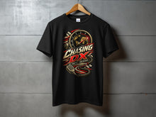 Load image into Gallery viewer, Black t-shirt with "Chasing DX" graphic featuring a world map, microphone, and speed dial.