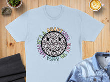 Load image into Gallery viewer, Light blue t-shirt with a smiley face graphic saying "It's a beautiful day to save lives."