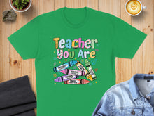 Load image into Gallery viewer, Green t-shirt with "Teacher You Are" text and crayon designs.