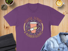 Load image into Gallery viewer, Purple t-shirt with "Coffee, Scrubs & Rubber Gloves" text and medical-themed graphic.