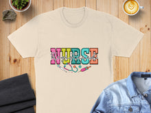 Load image into Gallery viewer, Cream t-shirt with "Nurse Registered" text and medical icons.