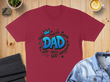 Load image into Gallery viewer, Burgundy t-shirt with "Dad" in blue bubble letters and surrounding words of praise.