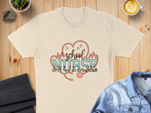 Load image into Gallery viewer, Beige t-shirt with "School Nurse" text and stethoscope graphic.