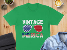 Load image into Gallery viewer, Green t-shirt with "VINTAGE AMERICA" and sunglasses graphic.