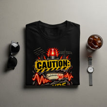 Load image into Gallery viewer, Black t-shirt with a "CAUTION" graphic featuring a siren, antennas, and a gauge.