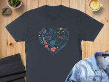 Load image into Gallery viewer, Dark t-shirt with a heart-shaped medical graphic featuring stethoscope, syringe, and pills.