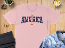 Load image into Gallery viewer, Pink t-shirt with "AMERICA" in blue, white, and red lettering and a red lightning bolt.