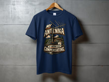 Load image into Gallery viewer, Navy t-shirt with "MY ANTENNA IS DEFINITELY COMPENSATING" graphic.