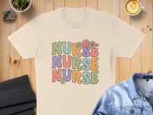 Load image into Gallery viewer, Cream t-shirt with "Nurse Nurse Nurse" in colorful retro lettering and floral accents.