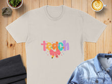 Load image into Gallery viewer, Cream t-shirt with "Teach" in colorful block letters and a pink bow.
