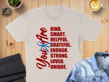 Load image into Gallery viewer, T-shirt with "You Are KIND. SMART. HELPFUL. GRATEFUL. ENOUGH. STRONG. LOVED. UNIQUE." text.