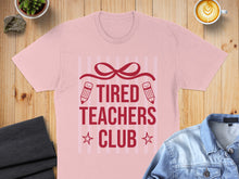 Load image into Gallery viewer, Pink t-shirt with "TIRED TEACHERS CLUB" text and pencil graphics.