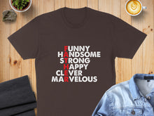 Load image into Gallery viewer, Dark brown t-shirt with white and red text "FUNNY HANDSOME STRONG HAPPY CLEVER MARVELOUS".