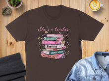 Load image into Gallery viewer, T-shirt with text "She's a teacher" and words Strong, Victorious, Beautiful, Capable, Greatly Loved.
