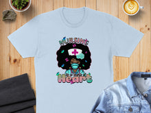 Load image into Gallery viewer, Light blue t-shirt with graphic of Black nurse with colorful butterflies and text "Nursing is a work of Heart".