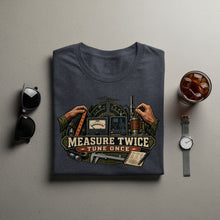 Load image into Gallery viewer, Dark t-shirt with "Measure Twice Tune Once" graphic featuring radio equipment and tools.