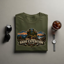 Load image into Gallery viewer, Olive t-shirt with "Radio Expedition Club" graphic featuring a scenic outdoor radio setup.