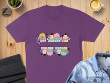 Load image into Gallery viewer, Purple t-shirt with cartoon pencils and flowers graphic split across chest.