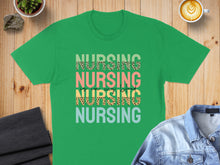 Load image into Gallery viewer, Green t-shirt with "NURSING NURSING NURSING NURSING" text in colorful, patterned lettering.