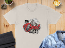 Load image into Gallery viewer, Cream t-shirt with "The Cool Dad" text and mountain graphic.