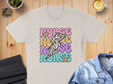 Load image into Gallery viewer, Nurse text with lightning bolts and flowers on a tan t-shirt.