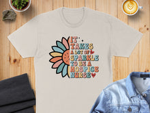 Load image into Gallery viewer, T-shirt with colorful sunflower and text "It takes a lot of sparkle to be a hospice nurse".