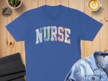 Load image into Gallery viewer, Blue t-shirt with "NURSE" in colorful, patterned letters.