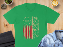 Load image into Gallery viewer, Green t-shirt with distressed American flag and "We The People" text.