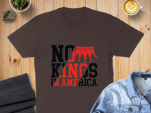 Load image into Gallery viewer, Brown t-shirt with "NO KINGS IN AMERICA" text and red crown graphic.