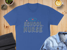 Load image into Gallery viewer, Blue t-shirt with "SCHOOL NURSE" text and a heart with a bandage.