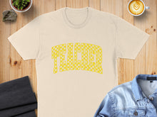 Load image into Gallery viewer, Cream t-shirt with yellow checkered "TEACHER" graphic, flat lay with denim jacket.