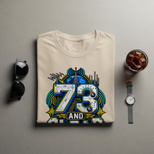 Load image into Gallery viewer, T-shirt with "73 AND" graphic featuring radio equipment and a globe.
