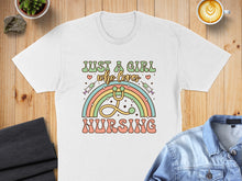 Load image into Gallery viewer, White t-shirt with "Just a girl who loves nursing" and rainbow stethoscope graphic.