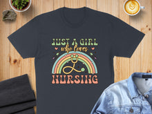 Load image into Gallery viewer, Dark t-shirt with "Just a girl who loves nursing" and rainbow stethoscope design.