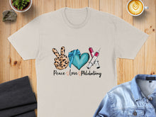 Load image into Gallery viewer, Peace love phlebotomy graphic on cream t-shirt with medical symbols.