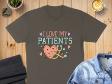Load image into Gallery viewer, Brown t-shirt with "I Love My Patients" text, heart, and stethoscope graphic.