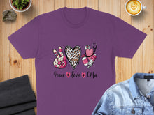 Load image into Gallery viewer, Purple t-shirt with peace sign, heart, stethoscope, and syringe graphic.