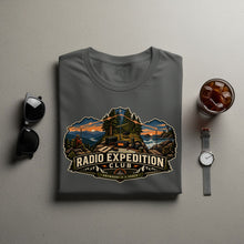 Load image into Gallery viewer, T-shirt with Radio Expedition Club graphic featuring a camping scene and the slogan "Anywhere is a Shack."