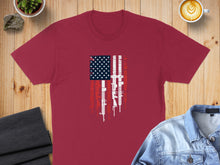 Load image into Gallery viewer, Maroon t-shirt with American flag design featuring rifles.