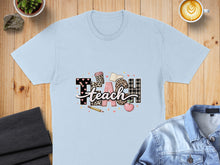 Load image into Gallery viewer, Light blue t-shirt with "TEACH" design in leopard print and plaid.