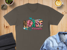 Load image into Gallery viewer, Brown t-shirt with "Nurse in progress" text and medical graphics.