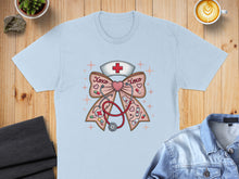 Load image into Gallery viewer, Light blue t-shirt with nurse's cap, stethoscope, and "XOXO" text forming a bow.